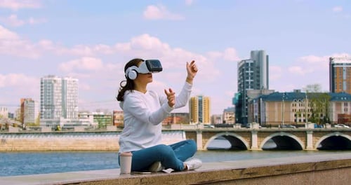 Woman Using VR Headset in Urban Environment