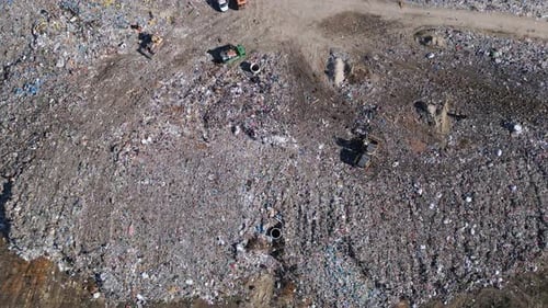 Aerial View of a Vast Landfill Where Bulldozers are Working and Trucks are Bringing New Waste Huge