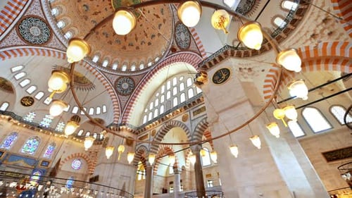 Interior view of the Suleymaniye mosque in Istanbul, Turkey. A lot of illumination, painted ceiling