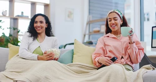 Two Friends Relaxing on Couch Watching Television