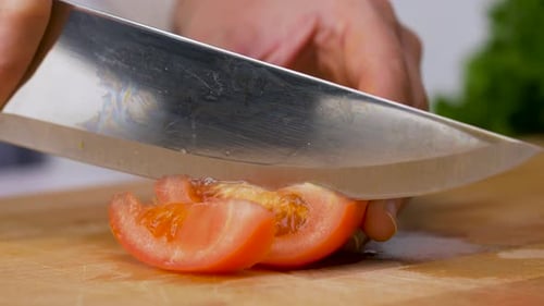 Healthy Eating, Vegetarian Food And Cooking Concept - Young Woman With Kitchen Knife Chopping Tom...