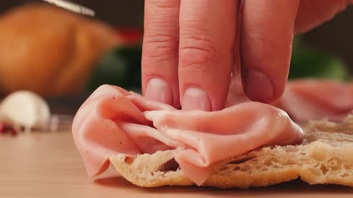 Ham Italian Mordatella Man Slices Of Traditional Italian Antipasti Mortadella Sausage on a Wooden