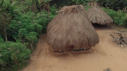 Thatched mud hut house in ancient Africa rural village compound