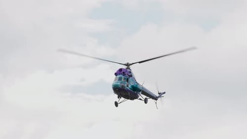 Teal and Purple Helicopter Flying in the Sky