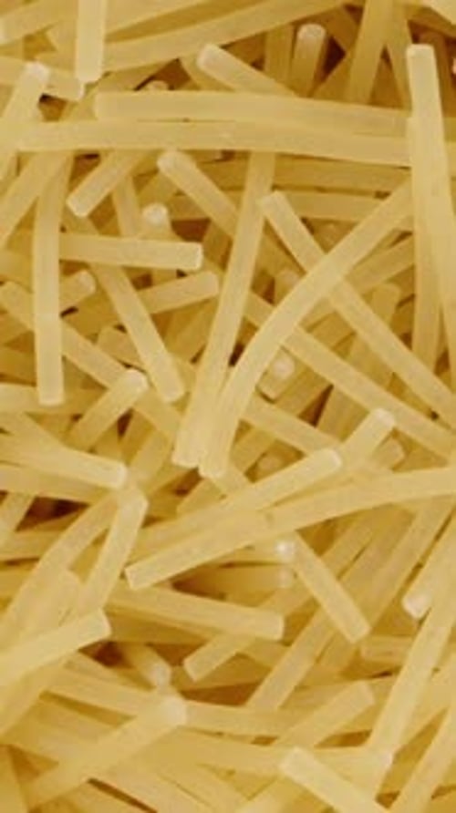 I take out noodles, pasta from the jar with my hand, top view. Dolly slider extreme close-up inside.