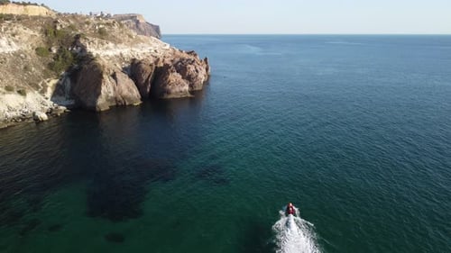 Scenic Cliffside Aerial with Boat on Turquoise Water