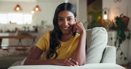 Woman Smiling Sitting on Couch Indoors