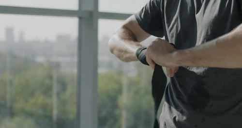 Closeup of Sportsman Wrapping Hands Preparing for Mixed Martial Arts Training in Gym