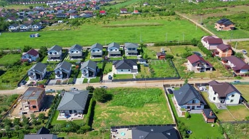aerial zooming and turning to show up-scale rural vacation homes in rural Romania