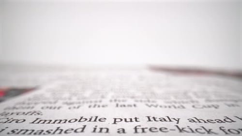 Words in the newspaper close up on white background isolated 4K
