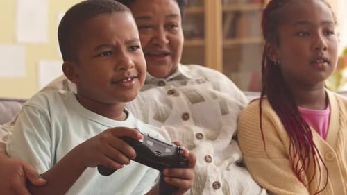 Family playing video games indoors