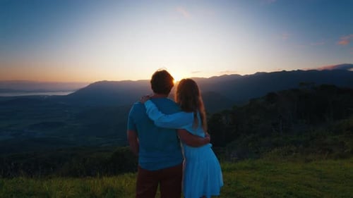 Couple Enjoy Sunrise in the Mountains