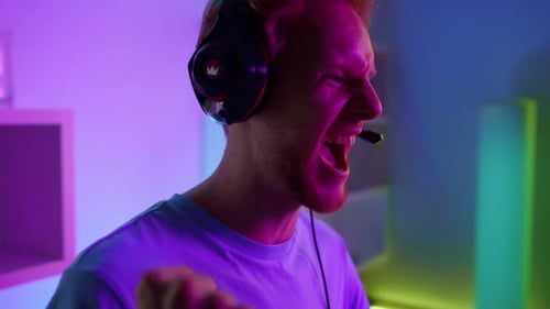 Overjoyed gamer celebrating online tournament victory in vibrant neon cyberspace studio