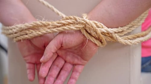 Abductor ties hands of victim preventing from escaping