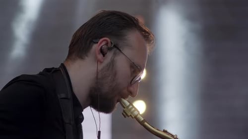 A Skilled Saxophonist is Performing Live on Stage Enhanced By Dramatic Lighting Effects Clip