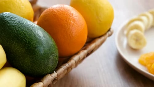 Assorted Fruits in Basket and Sliced on Plate