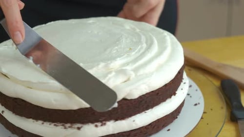Close Up of Woman Hands Making Sweet Cake with White Cream and Biscuit