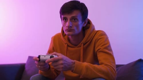 Man Plays Video Game at Night on Couch