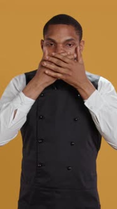 Vertical Video Restaurant Staff Covering His Eyes Mouth and Ears Against Evil in Studio
