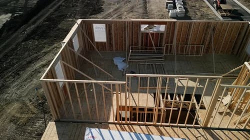 Aerial Drone Above View the a New House Under Construction Wood Framing Beams at Sunny Day