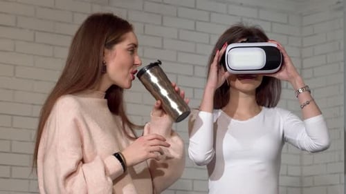 Two Women Using VR Headset Indoors