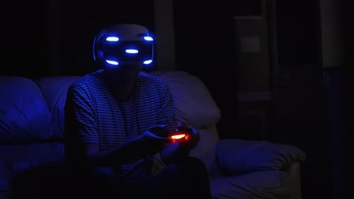 Man Immersed in Virtual Reality Gaming at Night