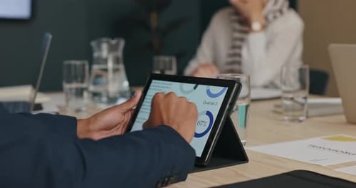 Business Meeting: Reviewing Data on a Tablet
