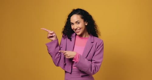 Happy woman, face and pointing with fashion for advertising or marketing on a studio background