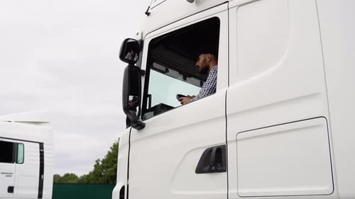 Truck Driver Man Sitting in Cabin