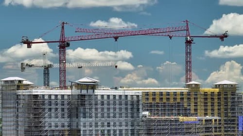 Tower Cranes and Frame Structure of High Residential Apartment Buildings at Construction Site