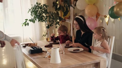 Family Celebrating Birthday at Home with Cake