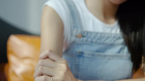 Woman Massages Sore Arm Muscles Indoors
