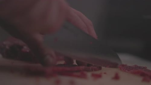Slicing Frozen Meat on a Wooden Cutting Board The Process of Cooking Food Thin Slices of Tender Meat