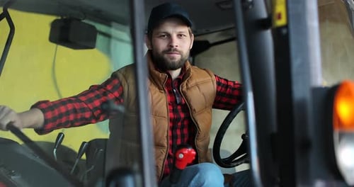 Farmer Smiling in Tractor Cab