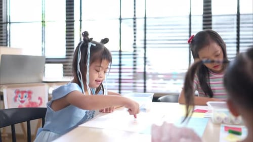 Children Drawing Pictures Together in School Classroom