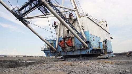 A Massive Excavator Operating at a Mining Site for Resource Extraction and Development Stock Clip