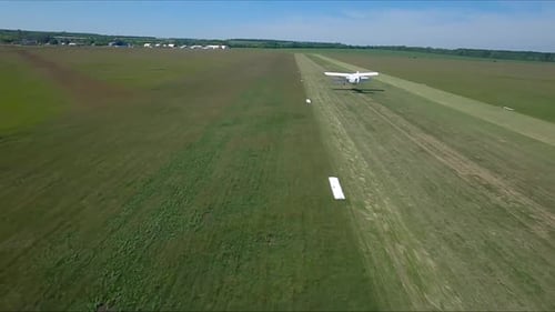 Old Airplane Takes Off From Grass Airstrip of Small Airport Retro Plane Move at Rural Runway and