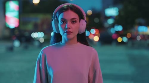 Urban Nights Woman in Headphones Under Neon Lights