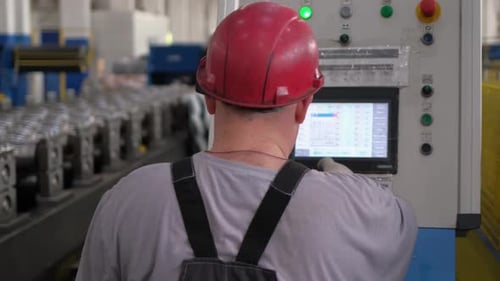 Factory Worker Machine Man Pressing Control Panel Display Buttons at Industrial Plant Industry