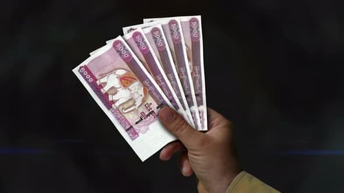 Myanmar Kyat money fan of banknotes in hand