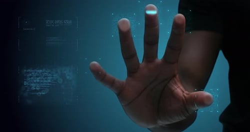 Hand scans futuristic interface with graphics on screen