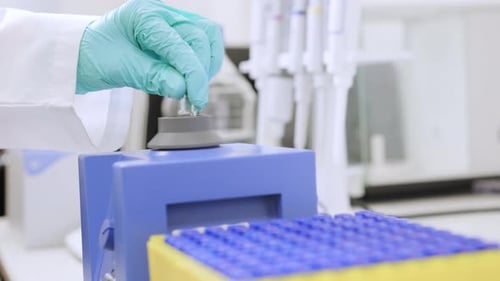 Close Up of a Chemist Shaking Samples Using a Vortex Mixer Before HPLC Analysis