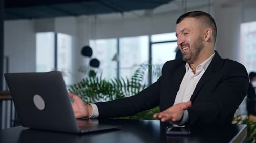 Successful businessman working in modern office. Happy confident smart young office worker.