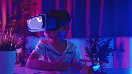 Child Wearing VR Headset at Desk
