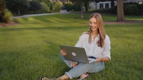 Woman Video Calling with Laptop in Sunny Park