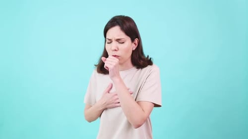 Woman Coughing on Turquoise Background