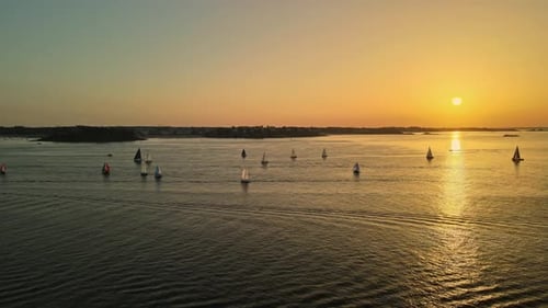 Sunset Over Sailboats on Calm Ocean Waters France