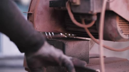 Cutting Bricks with a Circular Saw at a Construction Site
