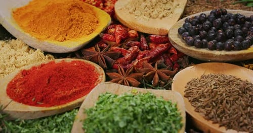 Close -up of a nice composition of spices and spoons on a turning base on bench. Concept: Food, tr