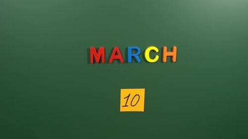 Hand sticking a sticker 10 March calendar day on school board. 10 date of March. Tenth day March